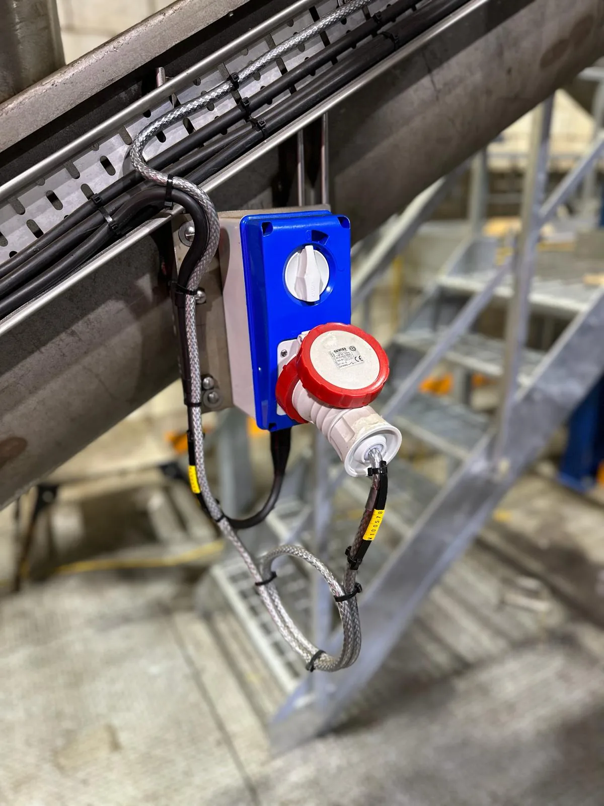 Three-phase socket outlet and rotary isolator serving conveyor equipment beneath the plant