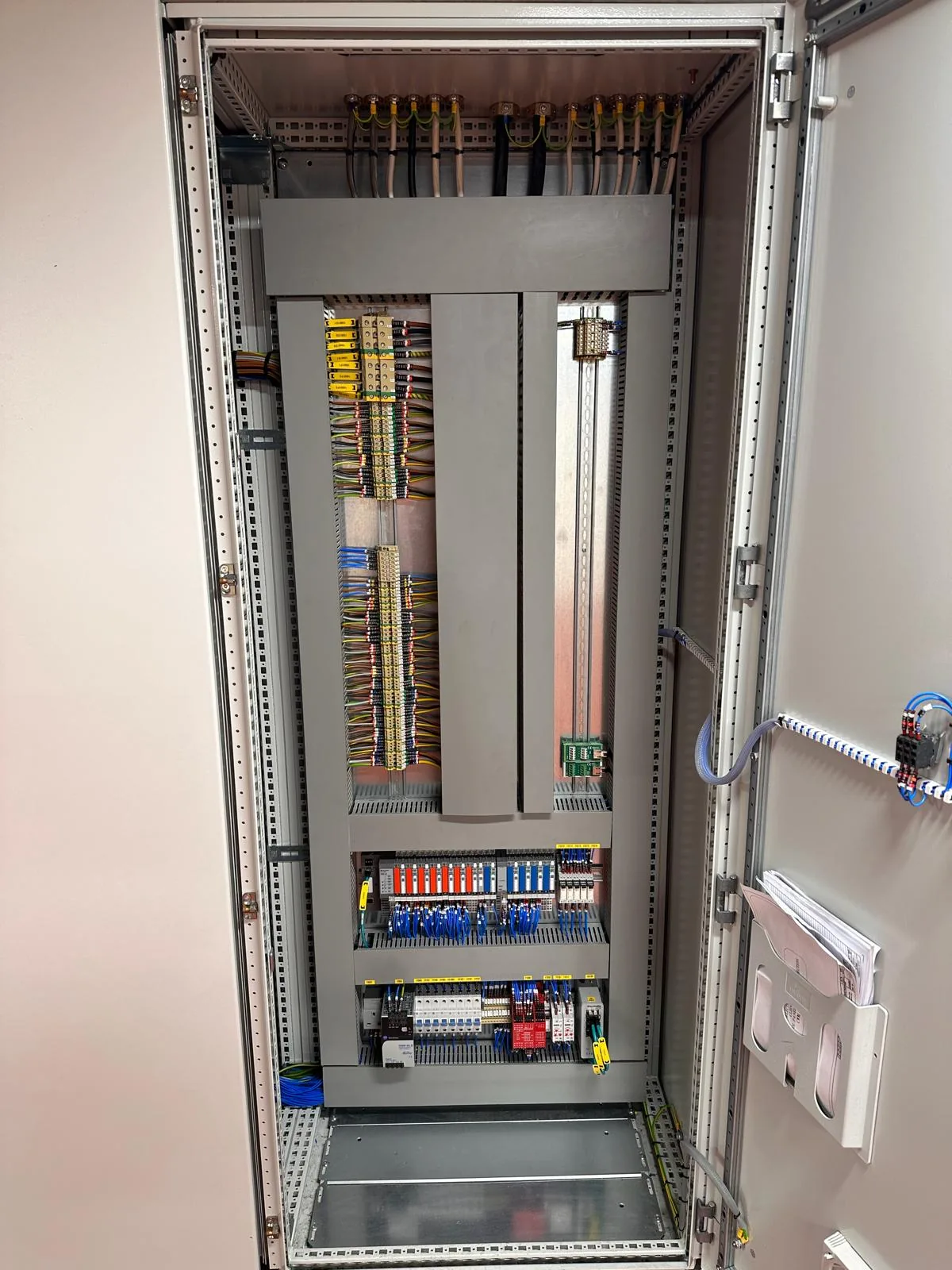 Variable speed drive panel internals showing busbar chamber, terminals and DIN rail equipment