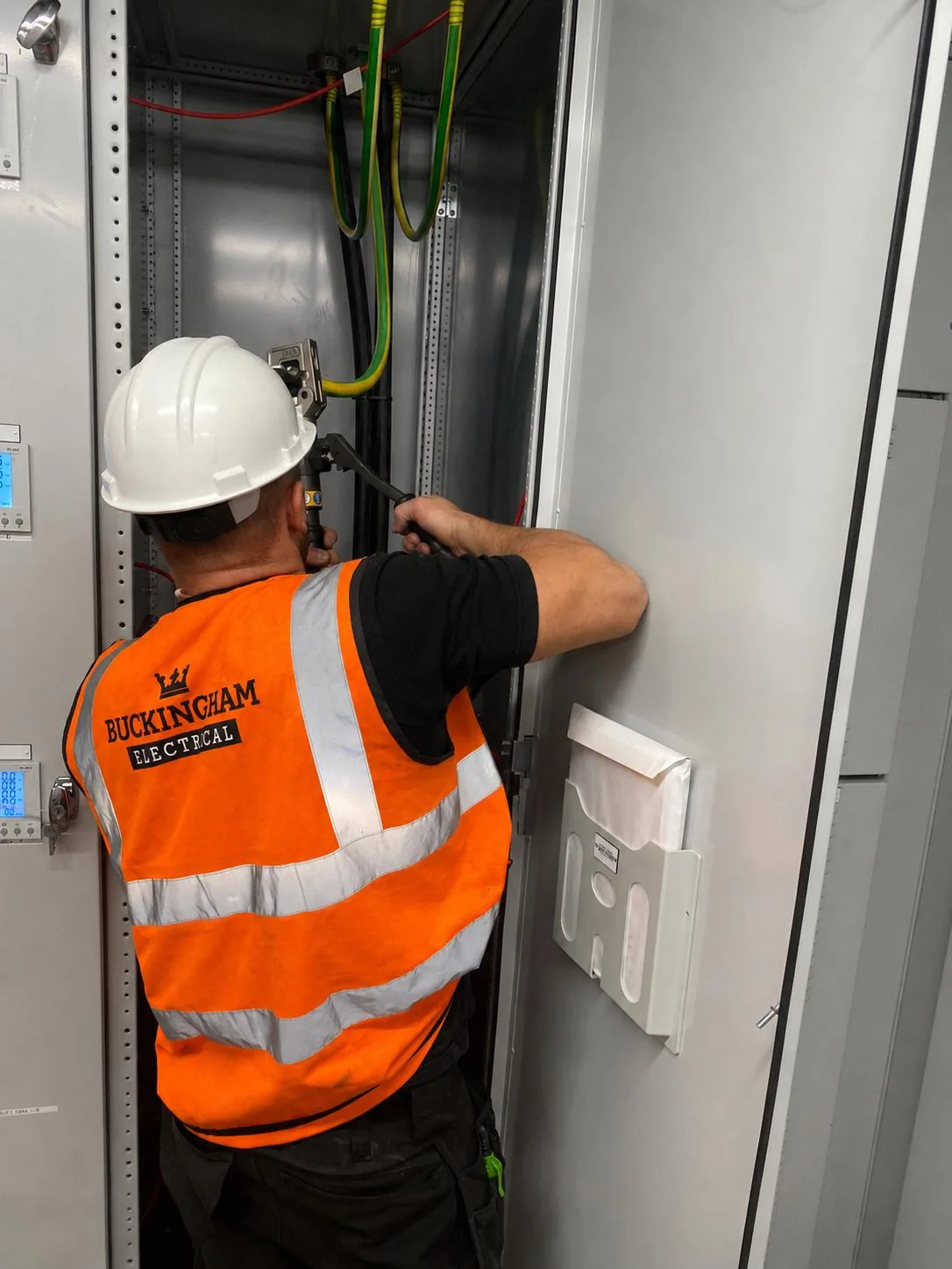Buckingham Electrical engineer working inside the motor control panel during installation