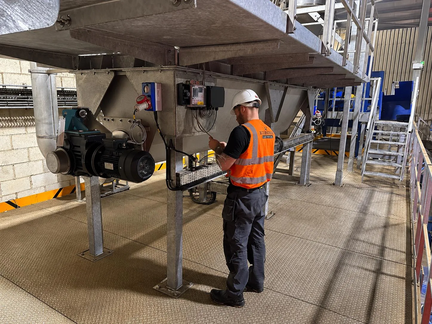 Engineer commissioning a conveyor screw drive at its local control station