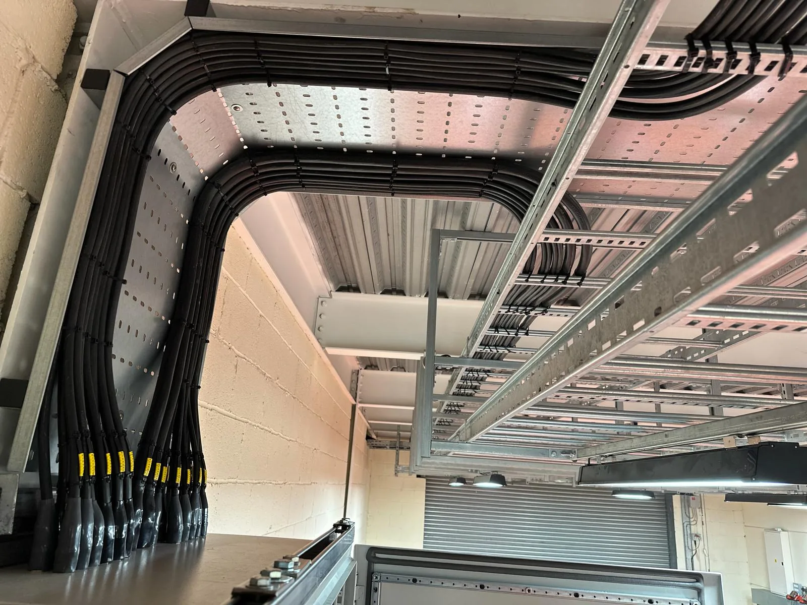 Bundled SWA power cables routed on cable ladder around a corner of the plant structure